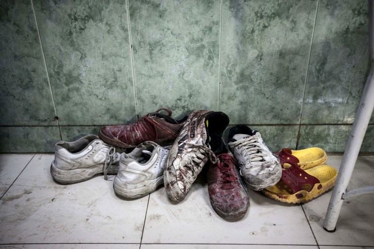 A pile of shoes covered by blood from wounded or dead residents lies at the entrance of the emergency ward at a hospital in the Tarik Al-Bab neighborhood in Aleppo on Nov. 1, 2012.