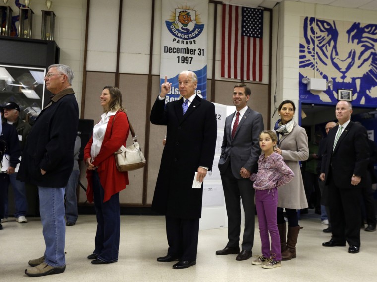 The vice president, accompanied by his son, Beau Biden, Beau's wife, Hallie, and their daughter, Natalie, stands in line to cast his ballot.
