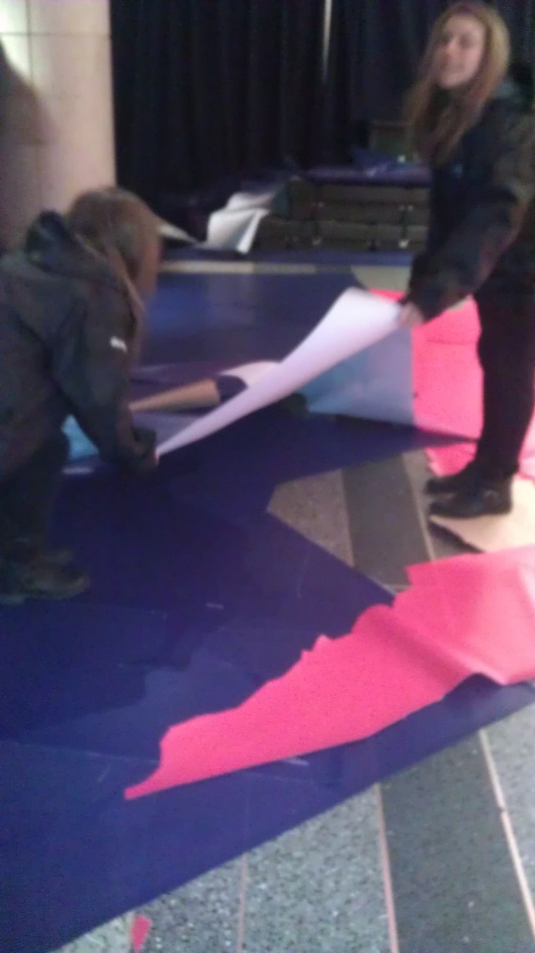 The crew removes the rejected vinyl cutouts.