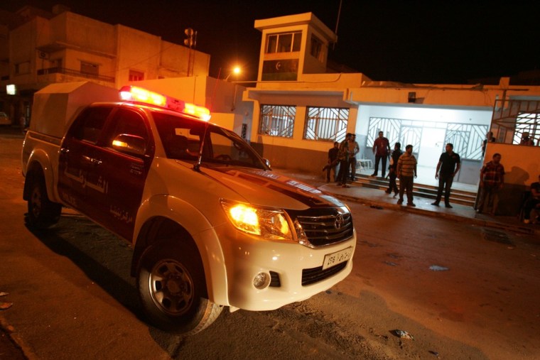 Libyan police officers stand on high alert Tuesday after a car, belonging to a police officer, exploded near the police station in Libya's eastern city of Benghazi.