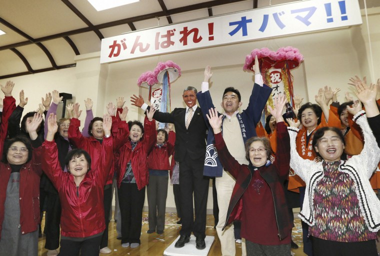 Staff and relatives of the Obama Onsen, or Obama hot spring, resort area shout