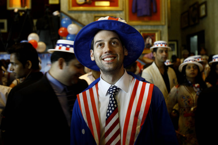 A U.S. citizen watches the live telecast of U.S. presidential election results in Mumbai, India, Nov 7, 2012.