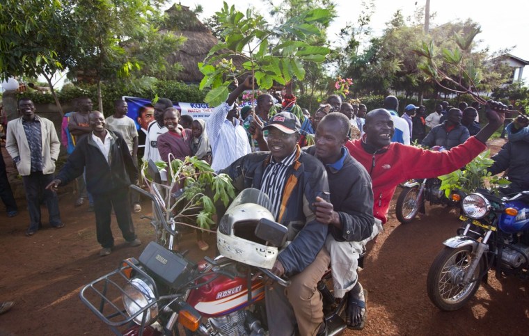 Villagers ride motorcycles and wave branches to celebrate Barack Obama's re-election, in the village of Kogelo on Nov. 7, 2012.