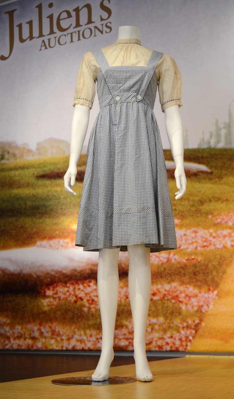 Judy Garland's blue gingham dress from \"The Wizard of Oz\" sold for $480,000 at auction on Nov. 10.