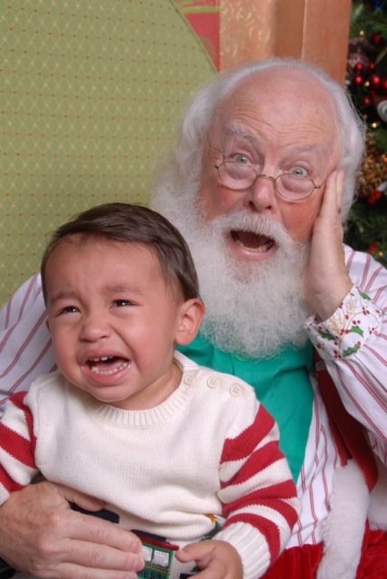 Tai, 18 months, is hurting Santa's ears!