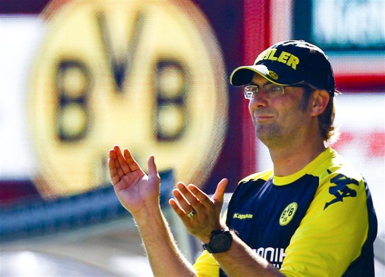 Borussia Dortmund's coach Juergen Klopp celebrates a goal of his team during the German Bundesliga first division soccer match against  A church in western Germany has bowed to public pressure and allowed the parents of a soccer-mad nine-year old boy who died from a brain tumour to erect a gravestone with a football after a Facebook campaign spawned more than 100,000 angry messages. REUTERS/Ralph Orlowski/File