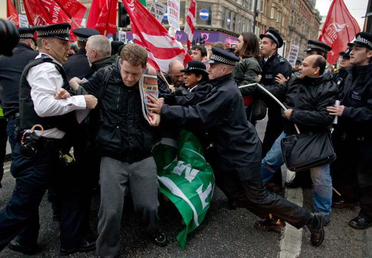 Police officers try to push protesters back onto the pavement after they blocked traffic on Oxford Street, London, while taking part in a picket and demonstration they said was over dismissals of 28 workers employed by contractors on the Crossrail transport project, for being trade union members, on Nov. 14. Crossrail, due to start running services in 2018, is a new train line that will include twin-bore 13 mile tunnels under central London and link 37 stations including transport hubs such as Heathrow airport with business districts including the City and Canary Wharf.