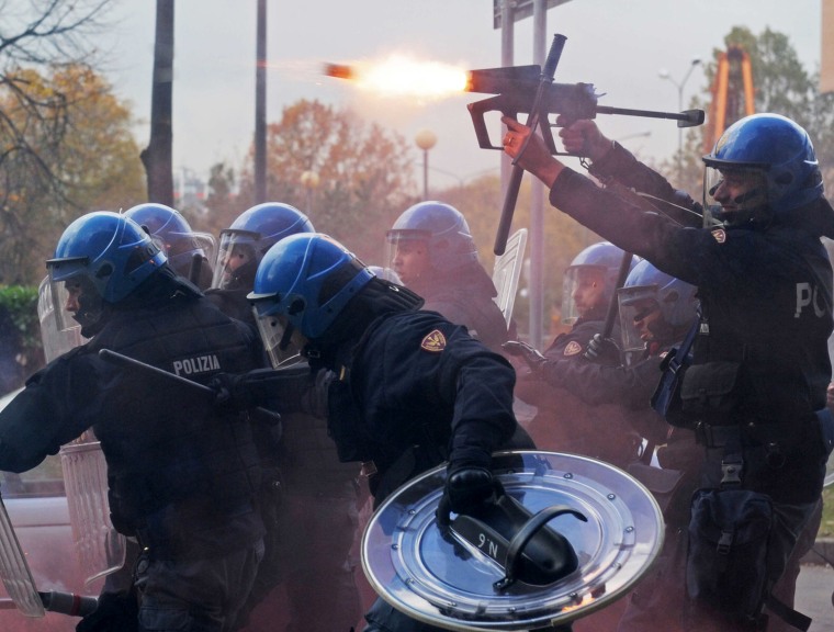 A police officer fires tear gas as police face demonstrators during a protest against Italian Government austerity measures in Turin, Italy, on Nov. 14. Workers across the European Union sought to present a united front against rampant unemployment and government spending cuts Wednesday with a string of strikes and demonstrations across the region. Protesters clashed with police in various demonstrations in Rome, Milan, Turin, Padua and Brescia.