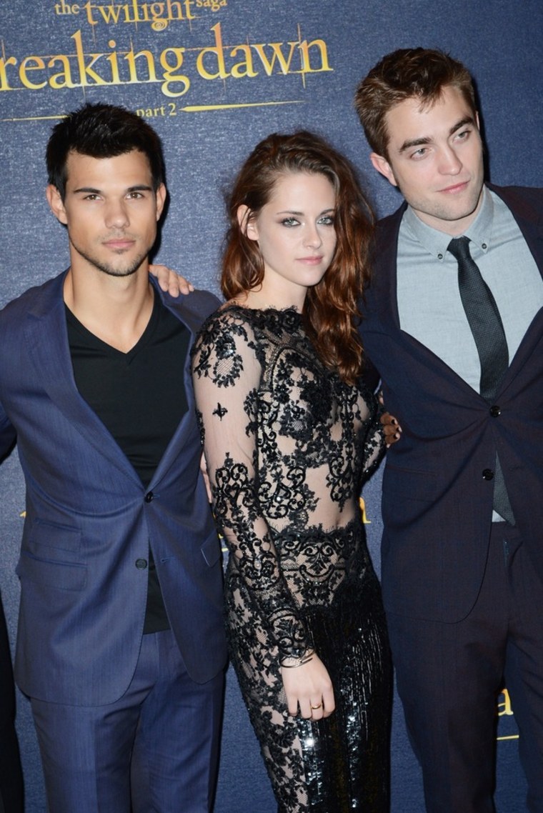 Beefcake sandwich: Taylor Lautner, Kristen Stewart and Robert Pattinson pose together at the premiere.