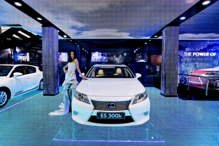 A model poses next to a Lexus ES 300h at the 2012 Beijing International Automotive Exhibition in Beijing on April 24.