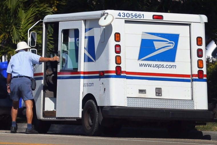 A U.S. Postal Service worker closes the door on his postal vehicle Thursday in Miami. The United States Postal Service reported a record annual yearly loss of $15.9 billion, more than triple the $5.1 billion loss last year.