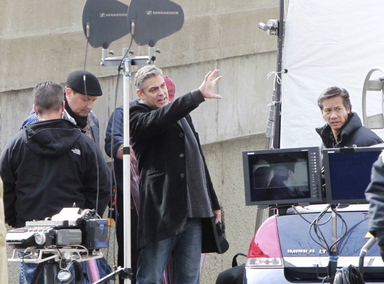 Actor-director George Clooney, center, works on the Cincinnati set of his political thriller