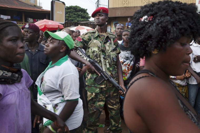 A military police officer stands guard at the final campaign rally for Sierra Leone opposition presidential candidate Julius Maada Bio in downtown Freetown, Nov. 15. Incumbent President Ernest Bai Koroma, a former insurance executive who came to power in 2007 in elections generally considered free and fair, will face off against former junta leader Bio.