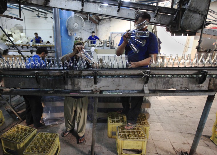 Workers at Pakistan's lone beer maker, Murree Brewery, line up empty beer bottles at the factory in Rawalpindi, Nov. 10, 2012.