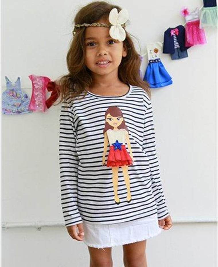 Kids can mix and match velcro-backed outfits on the \"paper doll\" affixed to these Lotty Dotty's shirts.