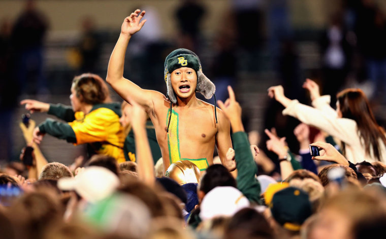 A Baylor Bear fan cheers on the field after a 52-24 win against the Kansas State Wildcats at Floyd Casey Stadium on Nov. 17, in Waco, Texas.