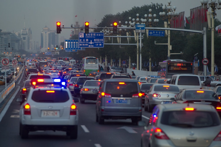 Heavy traffic passes Tiananmen Square outside the opening session of the Chinese Communist Party's five-yearly Congress at the Great Hall of the People in Beijing on Nov. 8.