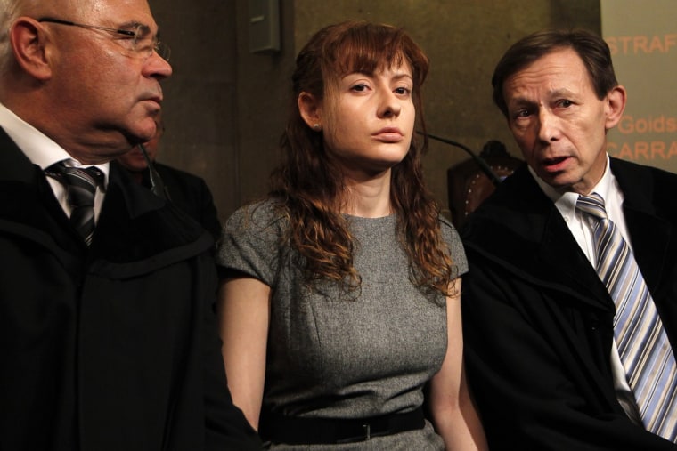 Estibaliz Carranza, seen here with her lawyers, is accused of murdering her husband and lover and setting their sawn-up body parts in concrete in the cellar of her ice cream parlor.