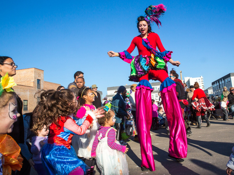 High spirits: A woman on stilts performs for children at the Rockaway Kids Carnival.