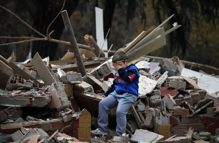 Saul Gabarri Valdes, 7, cries amidst the remains of his home after it was demolished at the Spanish gypsy settlement of Puerta de Hierro, on the outskirts of Madrid on Nov. 20.