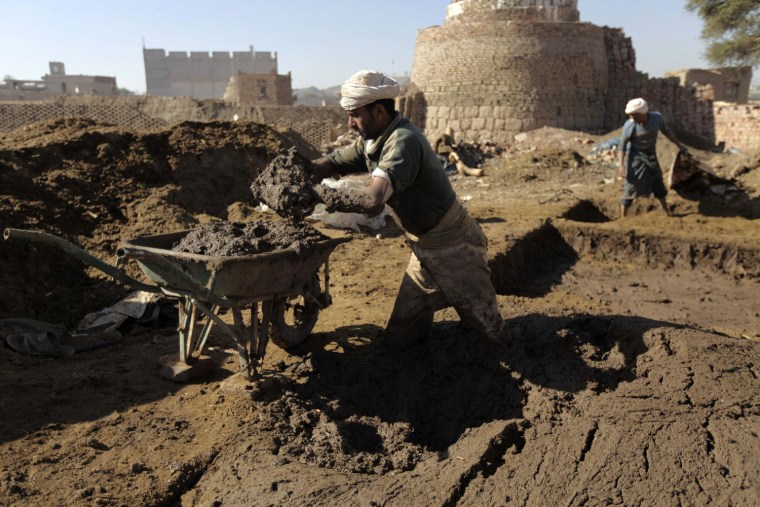 People work near a kiln at a traditional brick-manufacturing site in San'a, Yemen, Nov. 20.