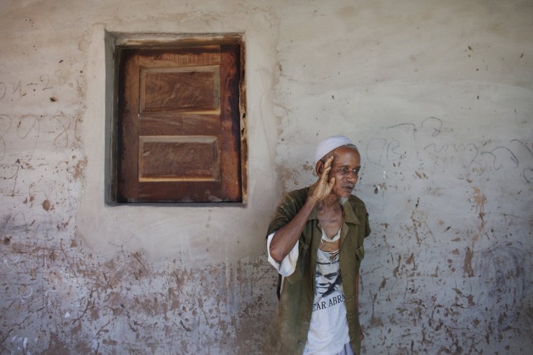 Former independence fighter Mamadu Sonaco Diallo, 80, gives a salute in Gabu, Guinea-Bissau, Nov. 3. Diallo joined the anti-colonial rebels to escape a life of raising cattle and became a specialist in clearing mines.