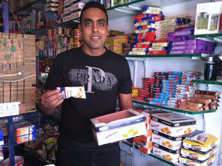 Mohamed Sarwat, who works at the Mecca Market in Ismailia, Egypt, shows off the Twinkies that the shop sells.