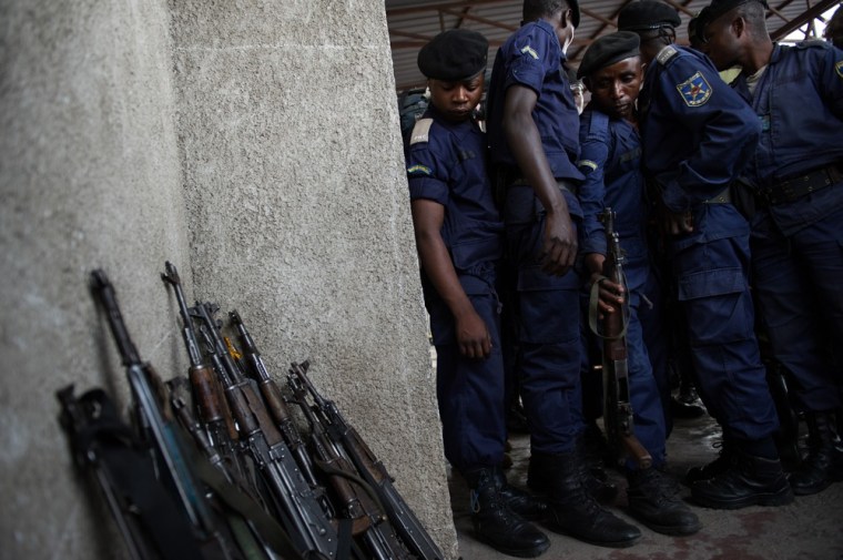 Surrendered police officers hand in their weapons at the Volcanoes Stadium in Goma, in the east of the Democratic Republic of the Congo, on November 21, 2012. M23 rebels, who took the city yesterday, called on any remaining policemen and army soldiers to assemble at the stadium this morning to officially surrender.