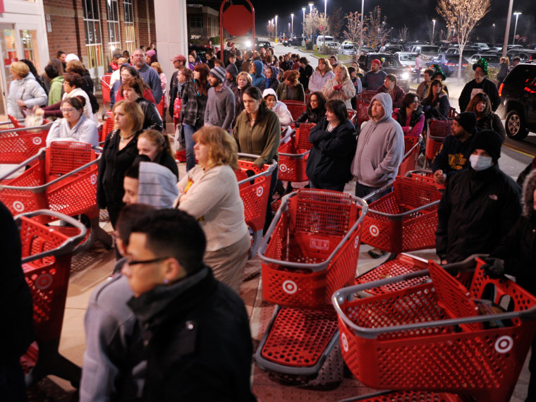 In this  Friday, Nov. 25, 2011, file photo, a crowd of shoppers wait outside the Target store in Lisbon, Conn., before the store opens for Black Friday shopping at midnight.