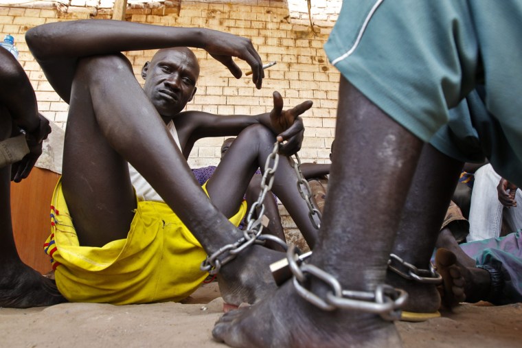Shackled inmates sit in the yard in Rumbek Central Prison in Rumbek, South Sudan, Oct. 24.