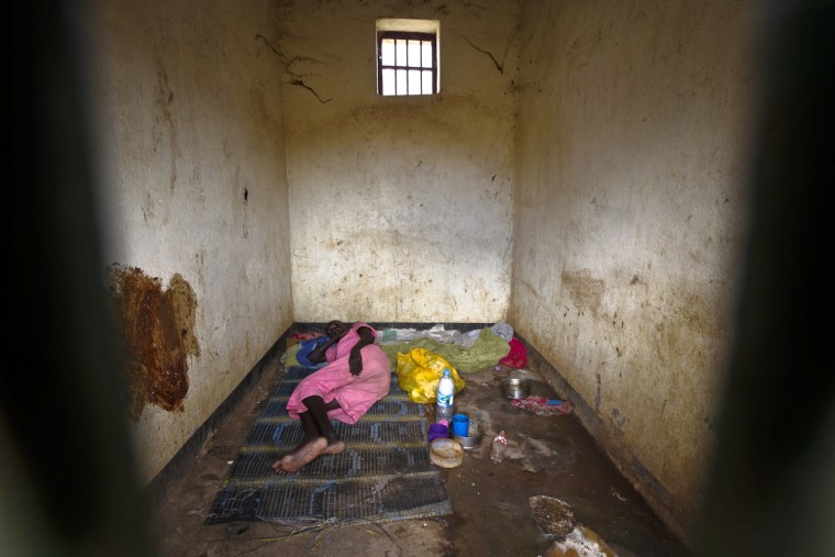 A female inmate, said to be mentally ill, lies down in her cell, soiled with her own urine and feces, in Juba Central Prison in Juba, South Sudan, Oct. 23.