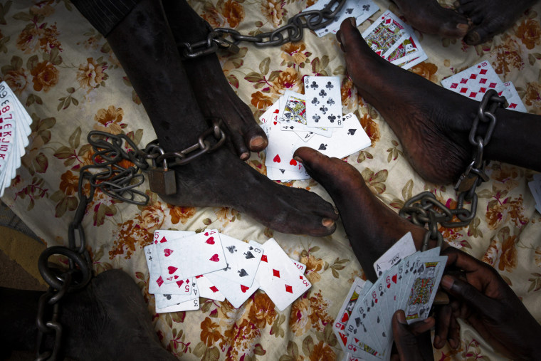 Shackled inmates play cards in Rumbek Central Prison in Rumbek, South Sudan, Oct. 25.