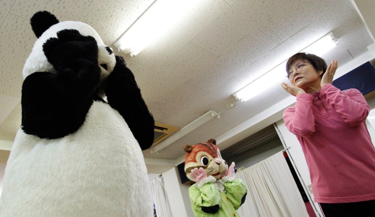 Choko Oohira (R) teaches trainees in character mascots on Wednesday.