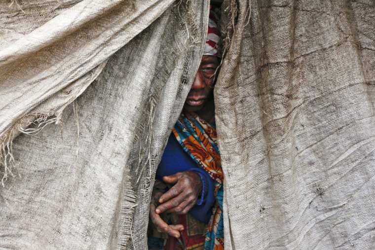 A woman who fled her home in Sake emerges from a shelter at an internally displaced person camp in Mugunga, between Goma and Sake, in eastern Democratic Republic of Congo, Nov. 22.