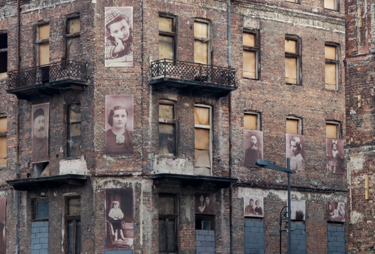 Photos of Jews who died during World War II adorn one of the few remaining buildings on Prozna Street in this picture taken during October of 2011 in Poland's Muranow district.