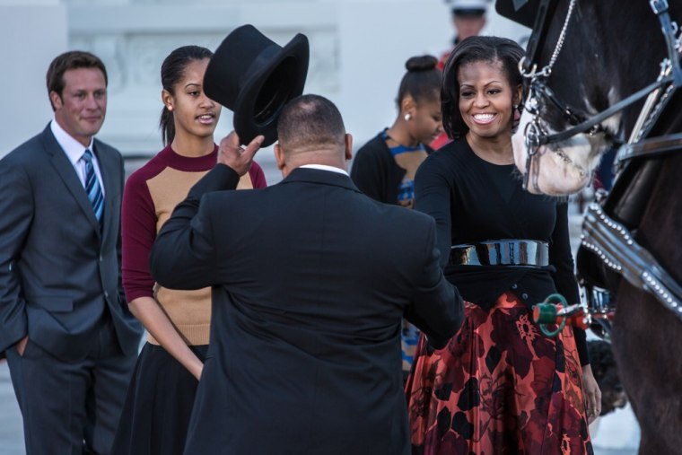 Michelle Obama (R) and Malia Obama (2nd L) are presented with the official White House tree, a 19-foot Fraser Fir from Peak Farms in North Carolina.