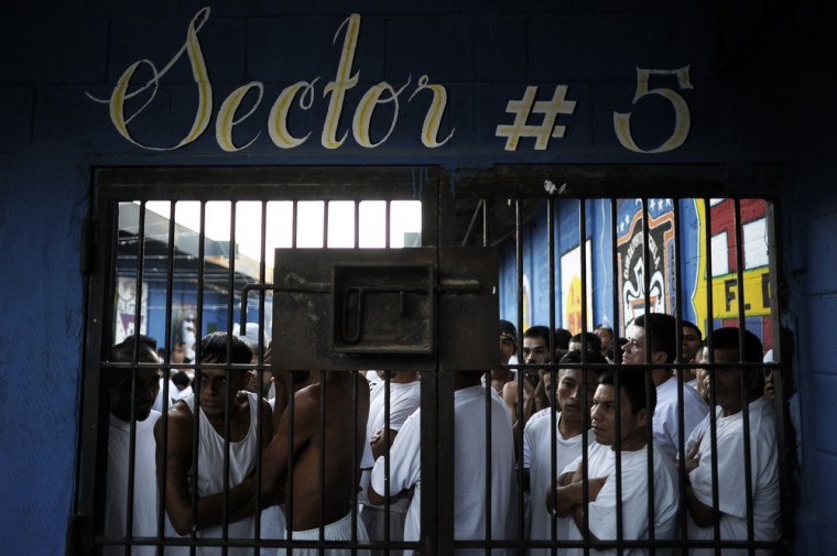 Inmates stand by a door at La Esperaza Jail in San Salvador.