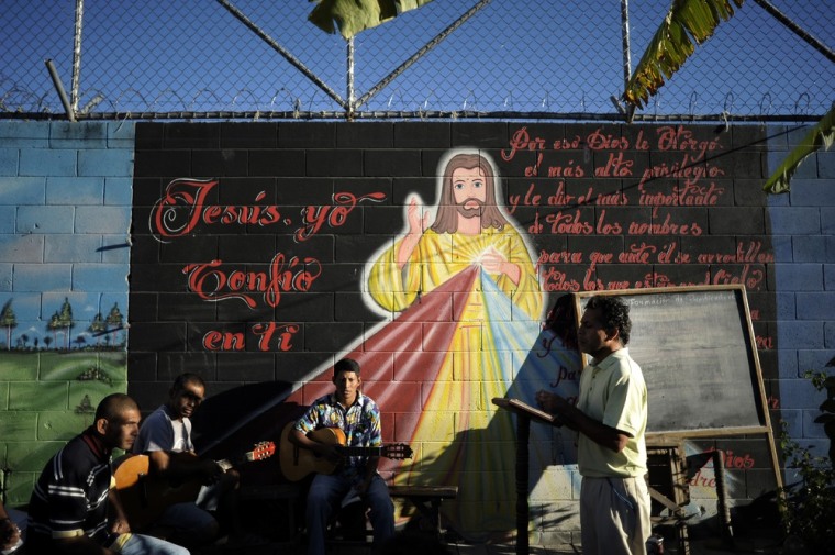 Inmates participate in a religious service at La Esperaza Jail.