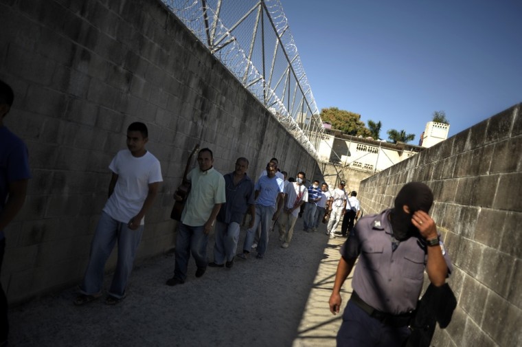 Inmates walk in line at La Esperaza Jail in San Salvador.