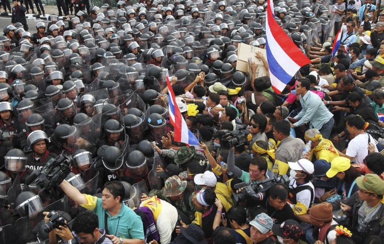 Police scuffle with anti-government protesters near the government house in Bangkok on Nov. 24.