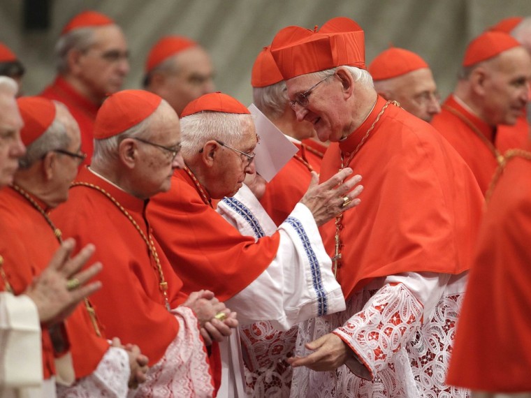 New Cardinal James Michael Harvey of U.S. (right) is congratulated by another cardinal during a consistory ceremony in Saint Peter's Basilica at the Vatican Saturday.