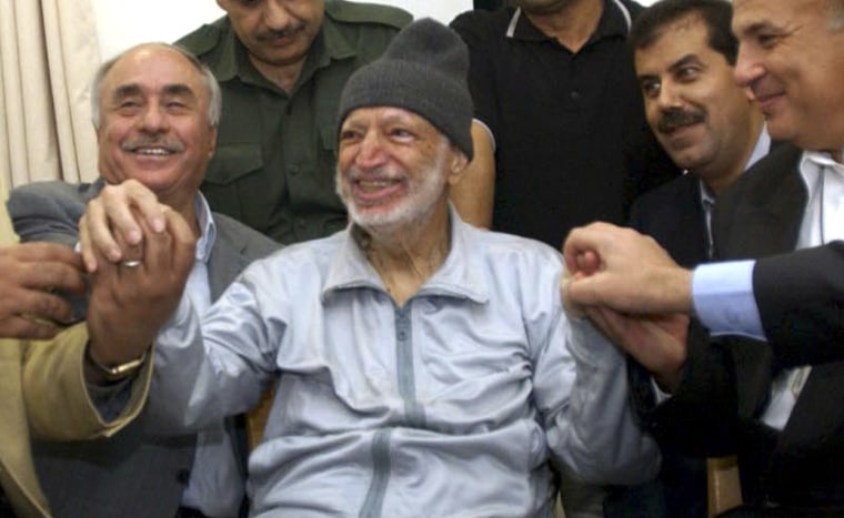 Then Palestinian President Yasser Arafat sits surrounded by doctors in his office in the West Bank City of Ramallah on Oct. 28, 2004.