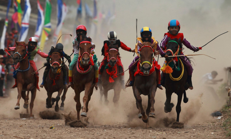 Child jockeys race their horses at a racetrack outside Bima, Indonesia, Nov. 17.