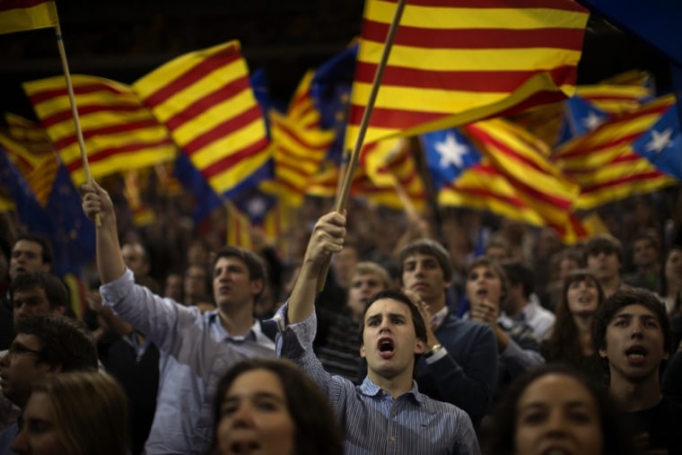 Supporters of center-right Catalan Nationalist Coalition (CiU) leader, Artur Mas, wave their pro-independence