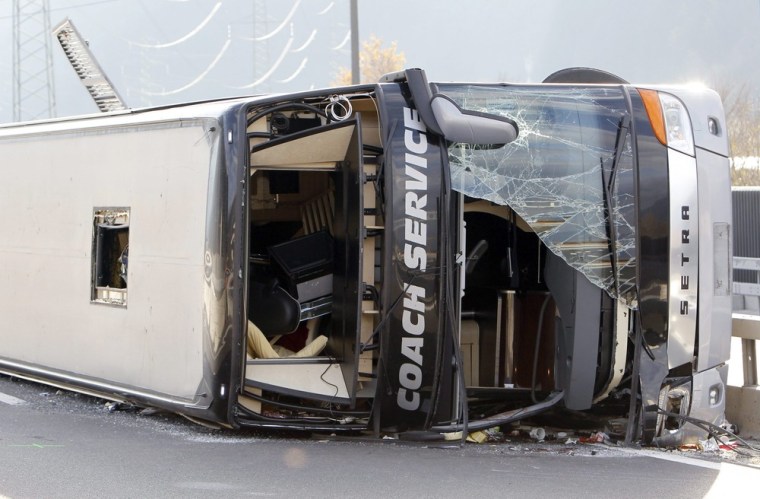 A tour bus lies on its side after crashing near Schattdorf, Switzerland, on Sunday, Nov. 25.