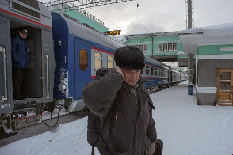 Valentin Danilov, a Russian physicist convicted of spying for China, tries to warm his ear as he arrives in Novosibirsk, the home of his wife of 41 years, on Nov. 26, 2012, two days after he was released on parole.