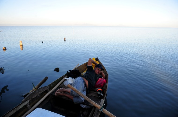 A fisherman rests on his boat on Xolotlan Lake in Tipitapa, some 12 miles from Nicaragua's capital, on Nov. 16.