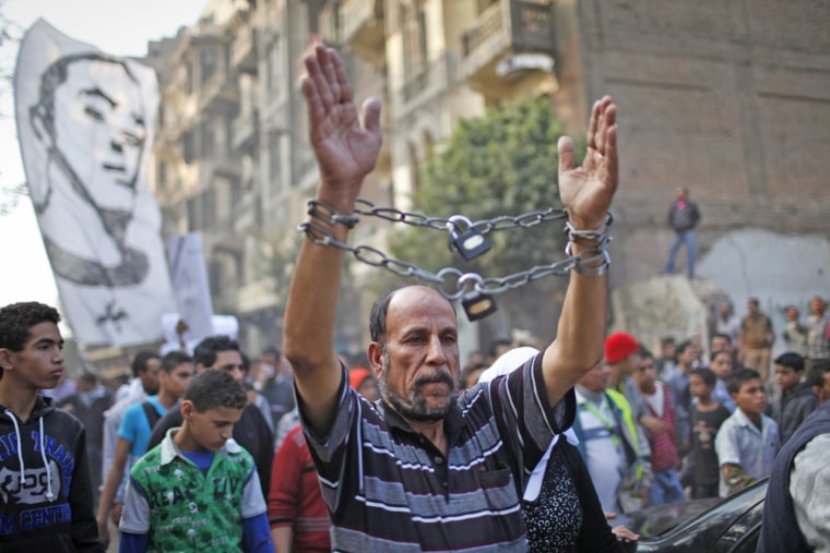 A mourner wearing chains attends the funeral of youth activist Gaber Salah.