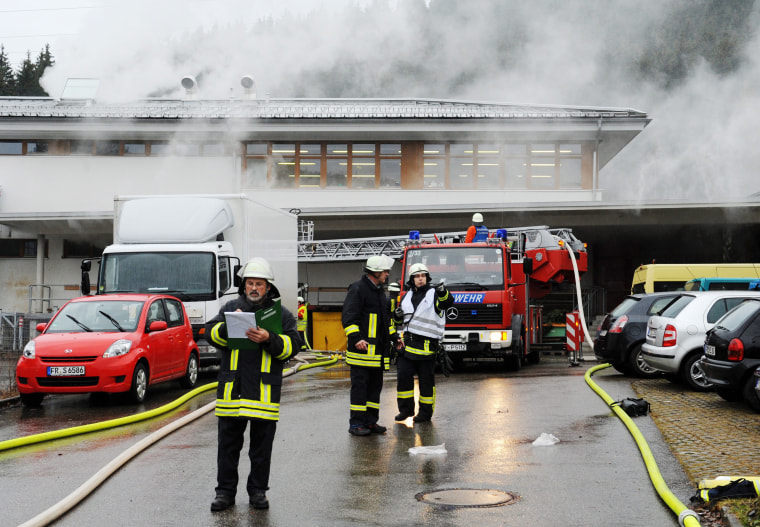 Firemen extinguish a fire at a workshop that employs disabled people in Titisee-Neustadt, Germany on Monday.