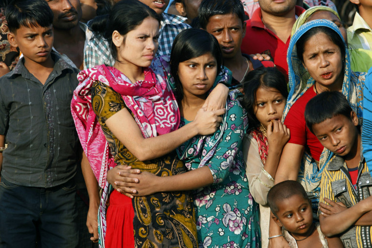 Women and children gather to attend a mass funeral at Jurain cemetery, in Dhaka, Bangladesh, Nov. 27.